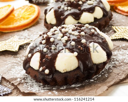 Christmas dessert chocolate tarts with whipped cream and glaze. Shallow dof.