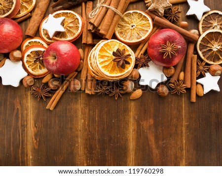 Christmas background made of nuts, dried oranges, and spices. Viewed from above.