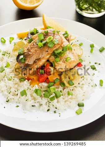 Steamed and baked sturgeon with stir-fry vegetables and rice. Shallow dof.
