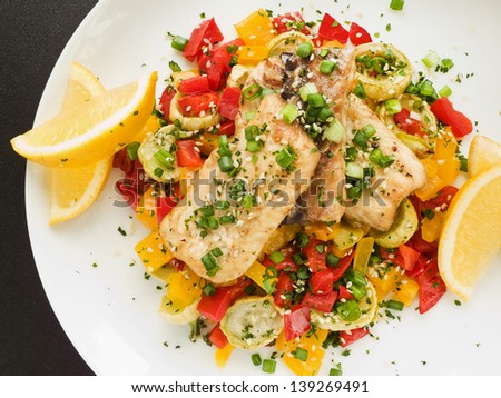 Steamed and baked sturgeon with stir-fry vegetables. Shallow dof.