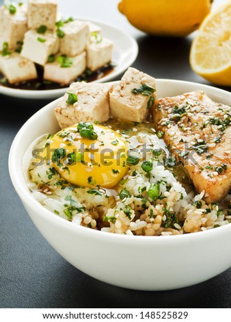 Bowl with jasmine rice, raw egg, sturgeon and vegetables. Shallow dof.