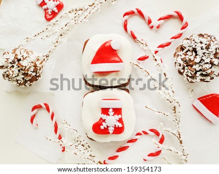 Chocolate cakes with whipped cream and christmas decorations. Viewed from above.