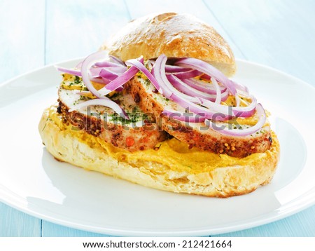Plate with sandwich with baked turkey, sauce and veggies. Shallow dof.