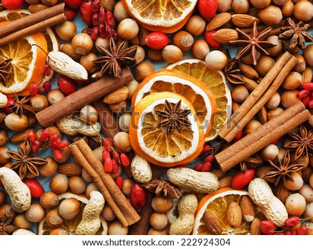 Christmas background made of nuts, dried oranges, and spices. Shallow dof.