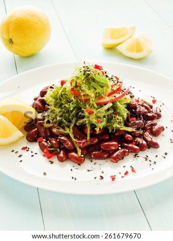 Japanese kaiso salad with red beans, lemon and red pepper. Shallow dof.
