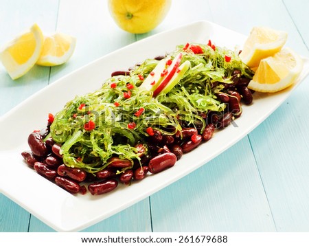 Japanese kaiso salad with red beans, lemon and red pepper. Shallow dof.
