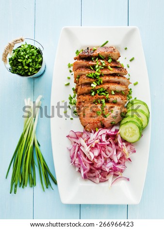 Argentinian Asado pork fillet with pickled onions. Shallow dof.