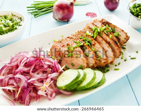 Argentinian Asado pork fillet with pickled onions. Shallow dof.