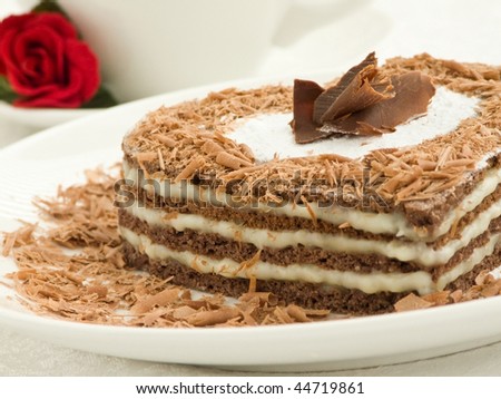 stock photo : Plate with sweet chocolate heart-shaped cake and coffee cup. Shallow dof.