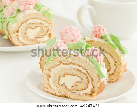Plate with homemade cream roll and coffee cup. Shallow dof.