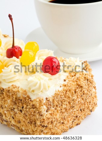 Homemade biscuit cream cake and coffee cup. Shallow dof.