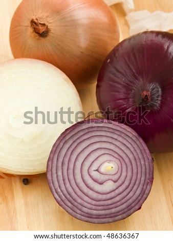 Lilac and gold onion on wooden background. Shallow dof.