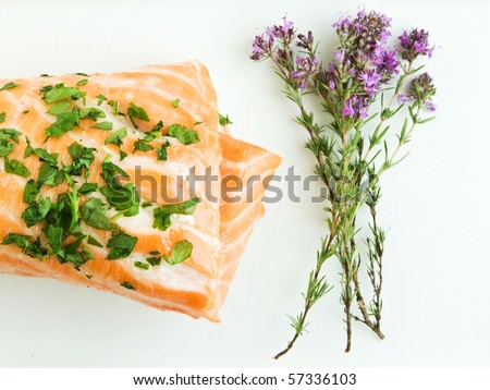 Plate with backed salmon and thyme bouquet. Shallow dof.