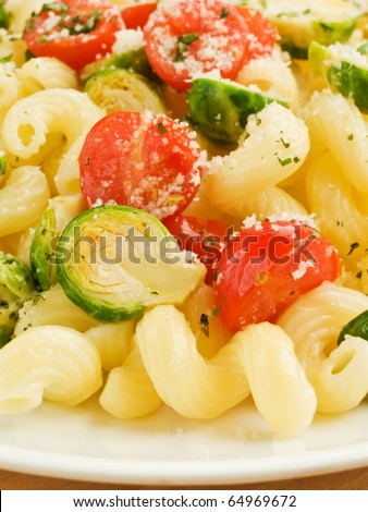 Italian pasta cavatappi with brussels sprouts and cherry tomatoes. Shallow dof.