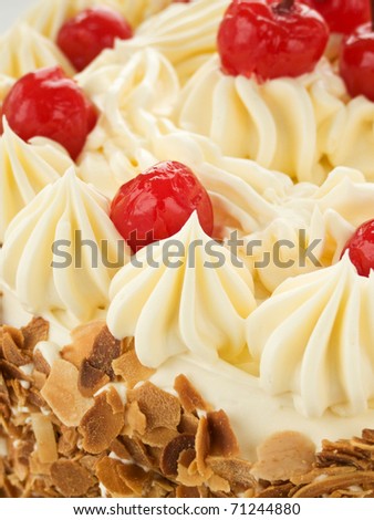 Delicious homemade cake with butter cream and cherries. Shallow dof.