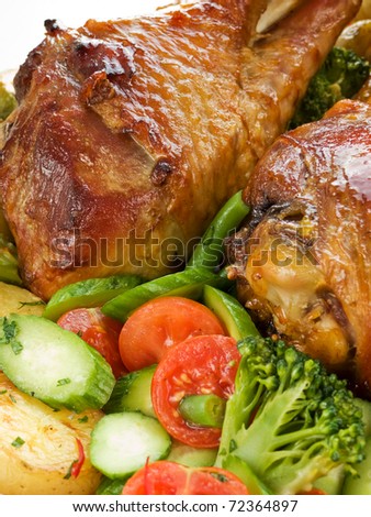Roasted turkey legs with vegetables. Shallow dof.
