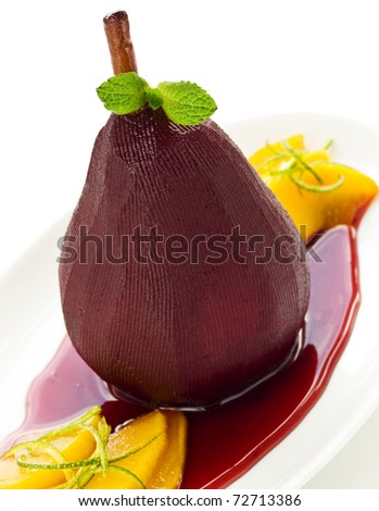 Poached pear in red wine with mango. Shallow dof.