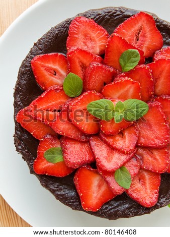 Homemade chocolate cake with strawberry and mint. Viewed from above.