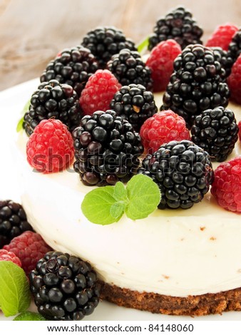 Sour cream cheesecake with raspberries and blackberries. Shallow dof.