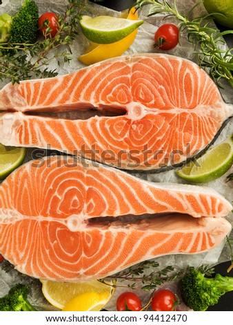 Fresh salmon, fruits, vegetables and herbs. Viewed from above.
