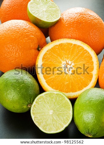 Mix of citrus fruits on the black background. Shallow dof.