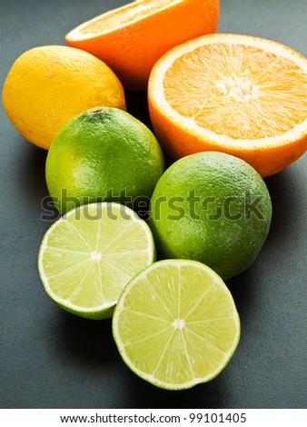 Mix of citrus fruits on the black background. Shallow dof.