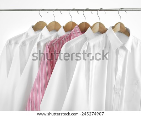ROW OF SHIRTS - Odd one out. A row of shirts hanging.
