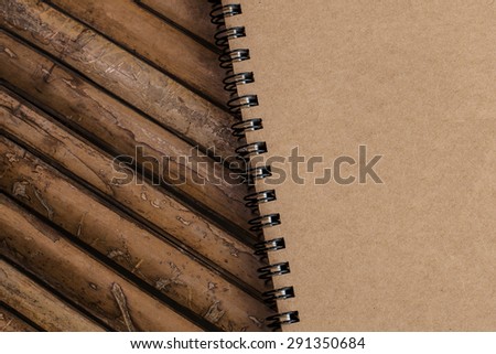 Closed Brown  note book on a bamboo background, simple texture