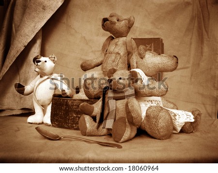 Photo of collection bears. They sit on a table in an environment of antiquarian subjects of a life. Bears are made of flax and filled by sawdust.