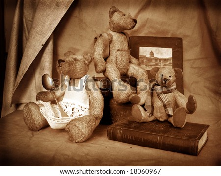 Photo of collection bears. They sit on a table in an environment of antiquarian subjects of a life. Bears are made of flax and filled by sawdust.