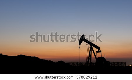 Silhouette of oil pump from oil field.