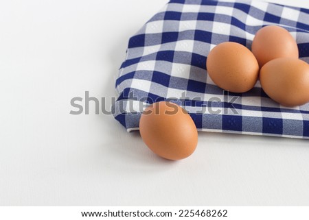 Fresh Eggs on blue dish cloth