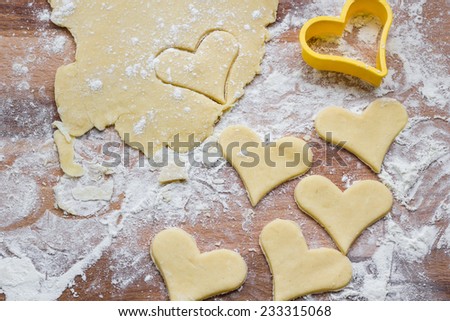 Baking heart shaped cookies on pastry board