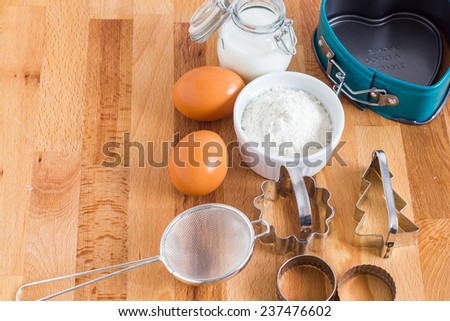 Baking ingredients on a wooden pastry board.