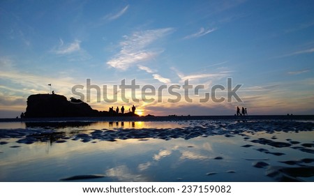 Sunset on Perranporth Beach Cornwall with people enjoying the surf sun and sand, shot during a sunset during summer 2014