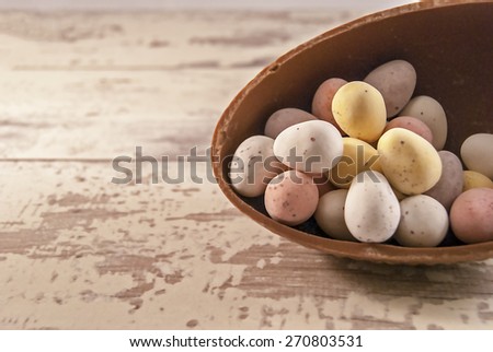 Illustration of mini eggs laying on a wooden background