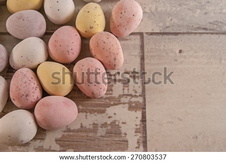 Illustration of  mini eggs laying on a wooden background