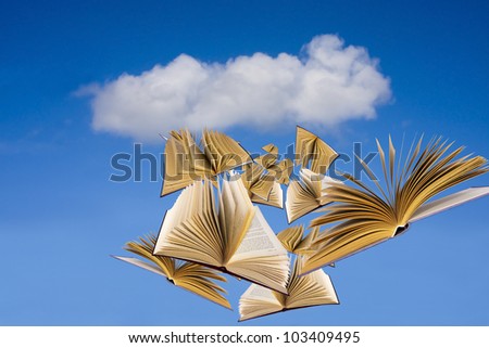 books flying over blue sky with clouds