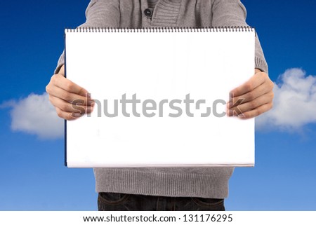 young adult holding the book or blank sign with