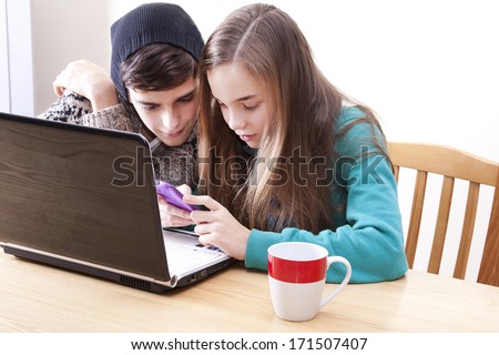 young teenagers with computer and phone happy