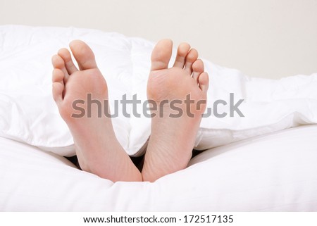 feet in the foreground in the covered bed
