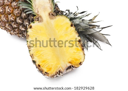 cut pineapple in the first plane and isolated on white background