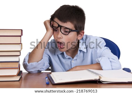 child at the table with books from school