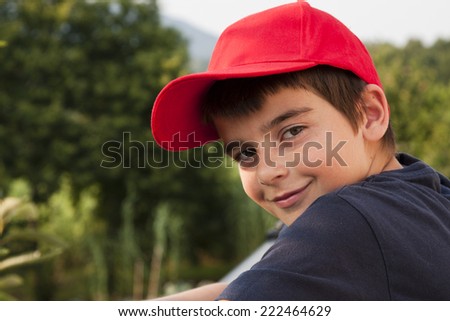 portrait of boy in the foreground with red cap