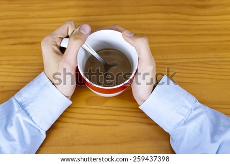 hands on the table with cup of coffee