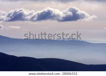 hills at sunrise with clouds