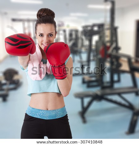 girl with boxing gloves in the gym