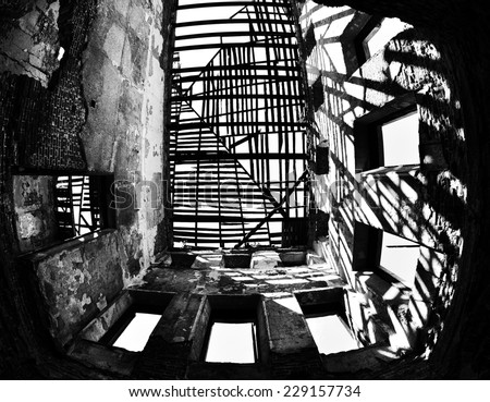 Abstract image inside abandoned house. Black and white textures of old stone, boards and shadows on the wall