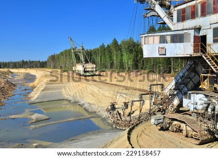 Mining and quarrying of sand. Giant excavators: abzetser and dragline in sand pit near Voskresensk, Russia