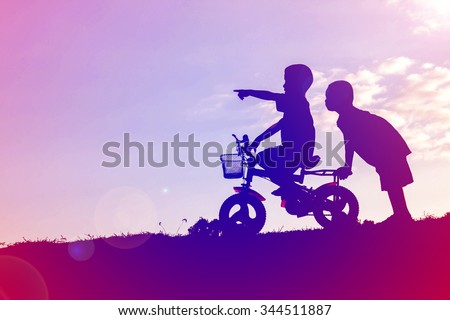 two little boys bike silhouette